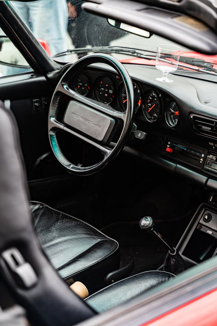 Classic car dashboard view featuring leather seats and manual gear shift shot in Bratislava.